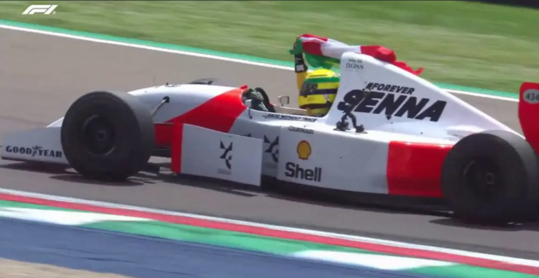 Las Banderas de Brasil y Austria ondeando con Sebastian Vettel al volante del MP4/8 de Senna, hoy en Imola