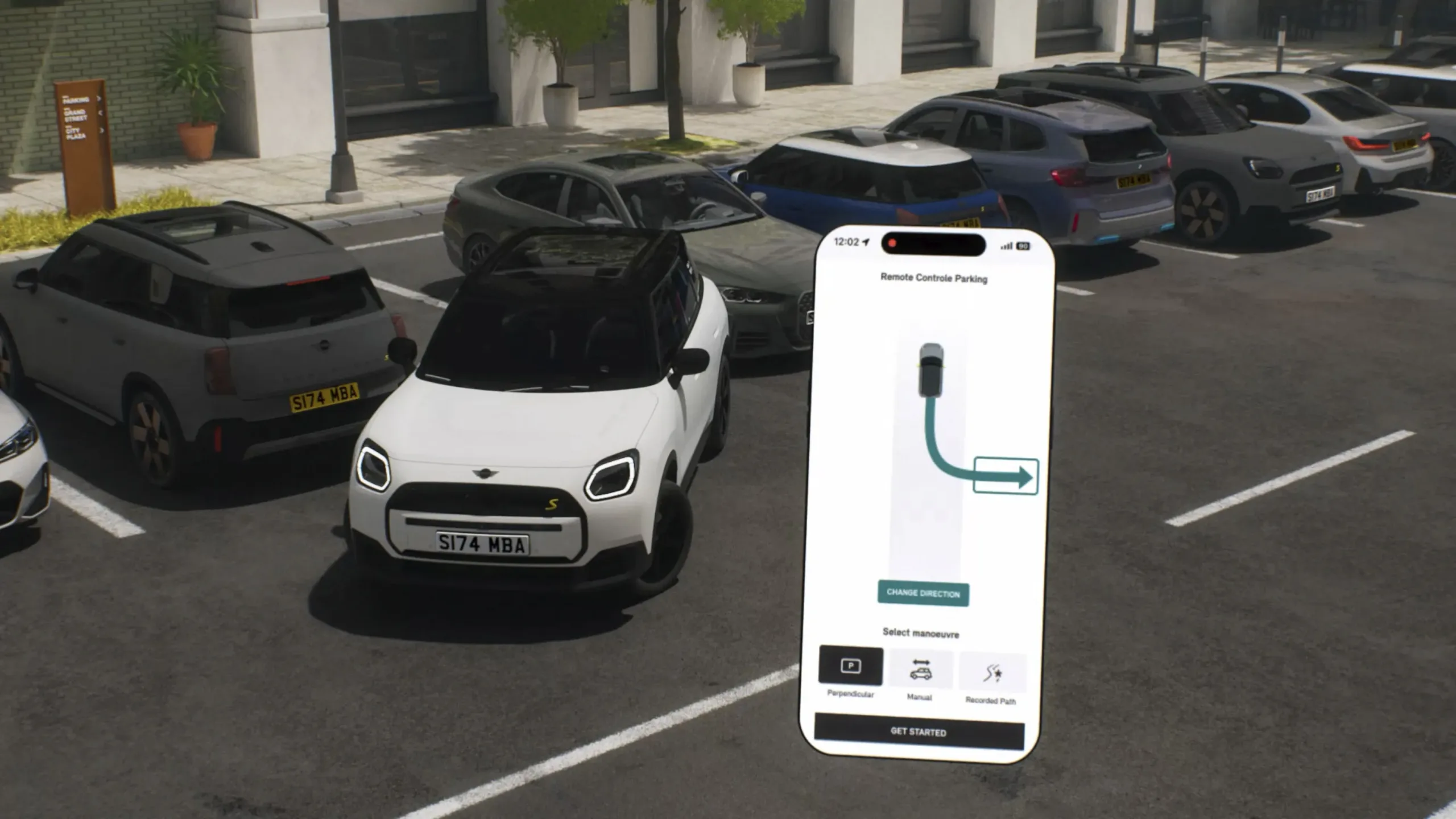 MINI blanco en un estacionamiento junto a un celular con la app de estacionamiento remoto en pantalla