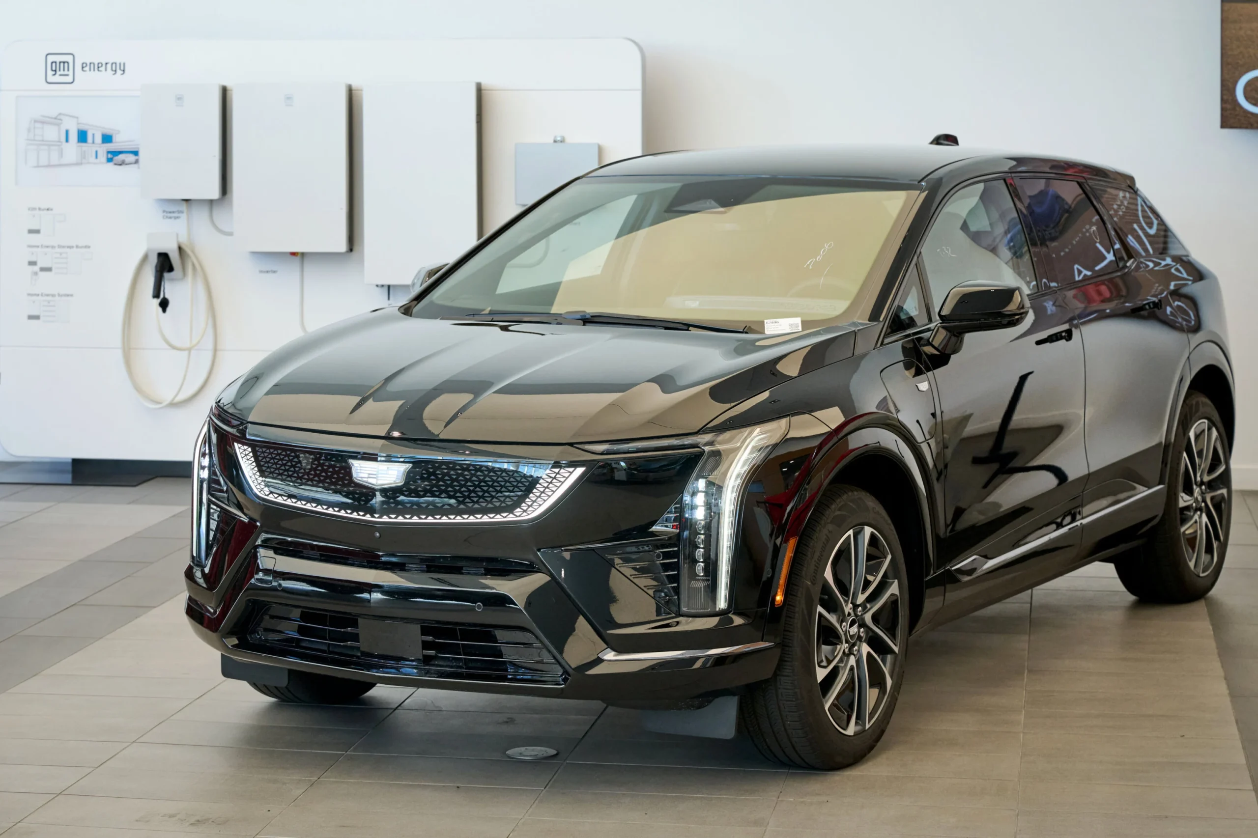 Smart Charge Bundle: SUV eléctrico Cadillac negro junto a cargadores domésticos GM Energy en un concesionario