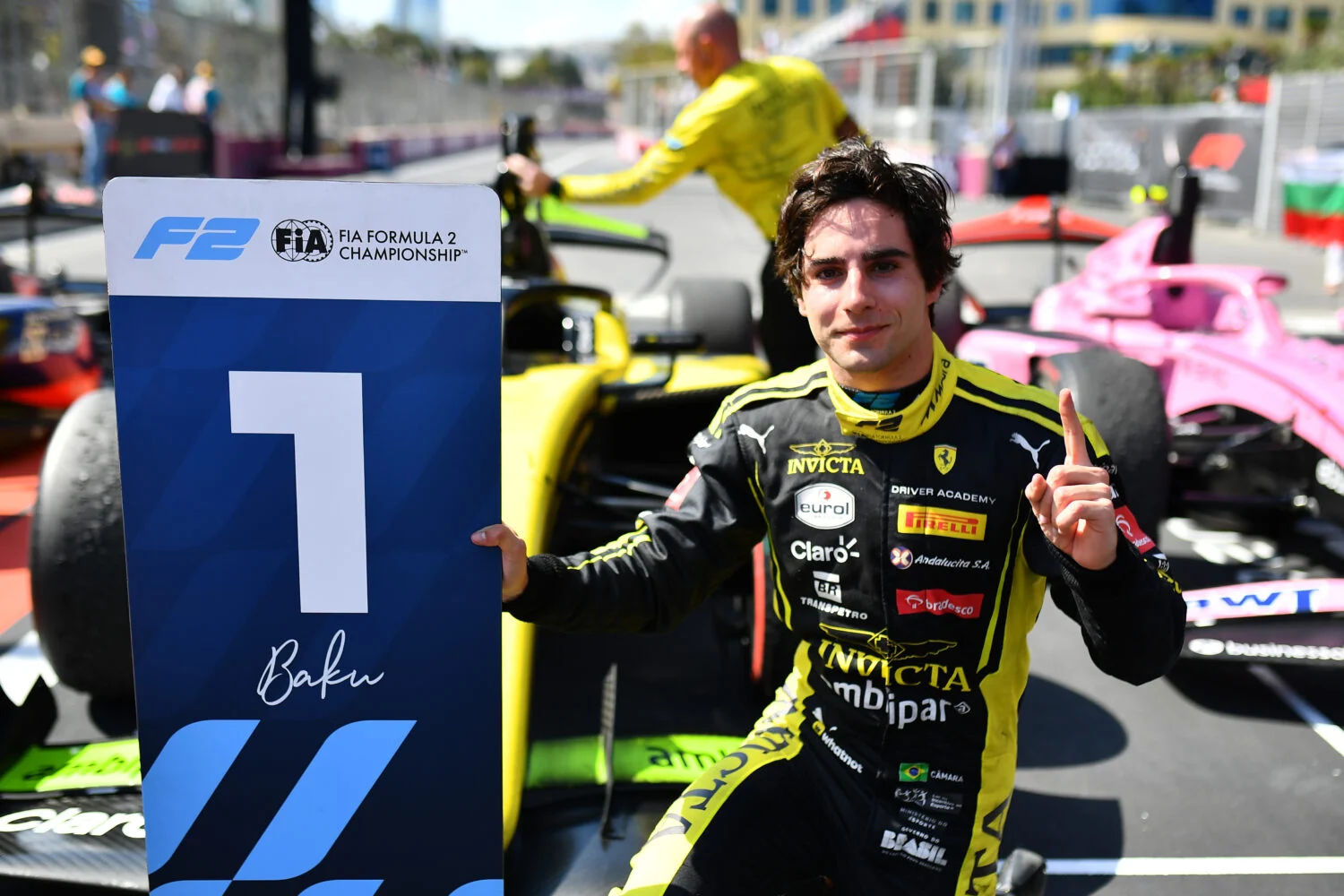 Rafael Câmara celebra con el cartel de ganador de Fórmula 2 en Bakú junto a su monoplaza de Invicta Racing