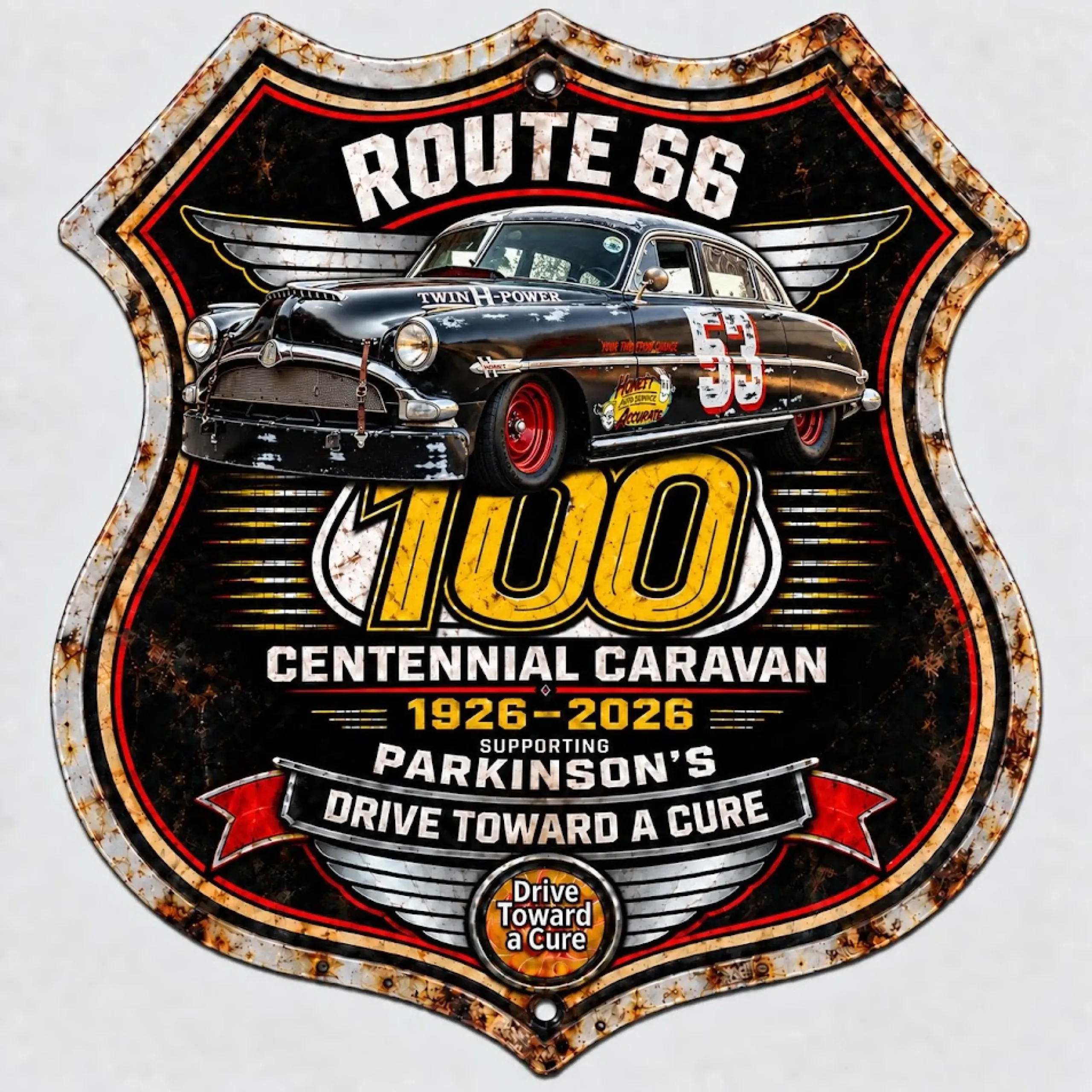 Insignia de la caravana del centenario de la Ruta 66 con un Hudson Hornet y el lema de Drive Toward a Cure