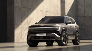 Hyundai Tucson gris en un estudio de hormigón, vista de tres cuartos delantera con la firma luminosa H-Edge