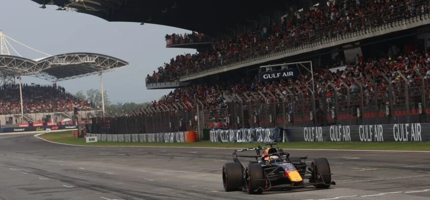 Monoplaza de Red Bull en la recta principal de Sepang durante el GP de Bahréin, frente a la tribuna llena