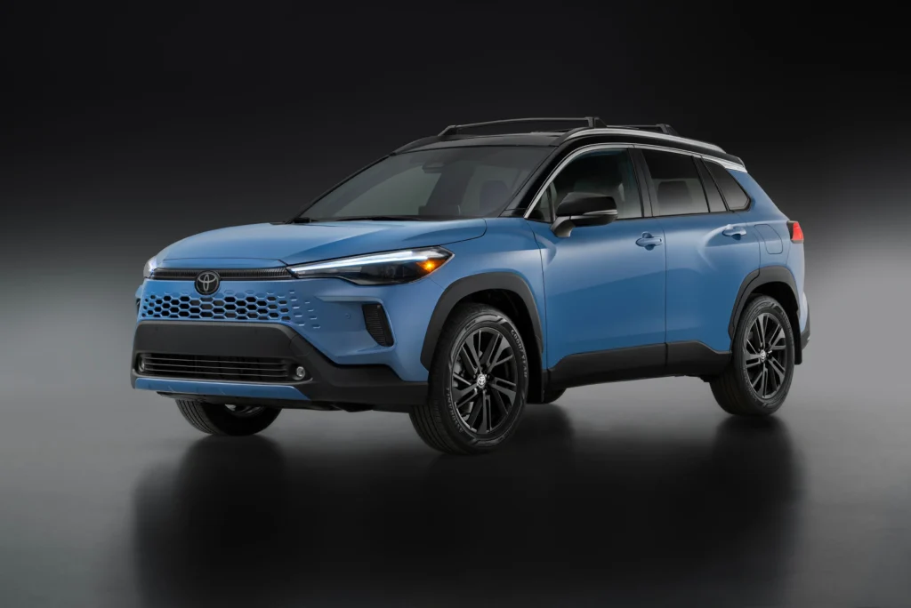 Toyota Corolla Cross Hybrid XSE azul con techo negro en un estudio, vista de tres cuartos delantera