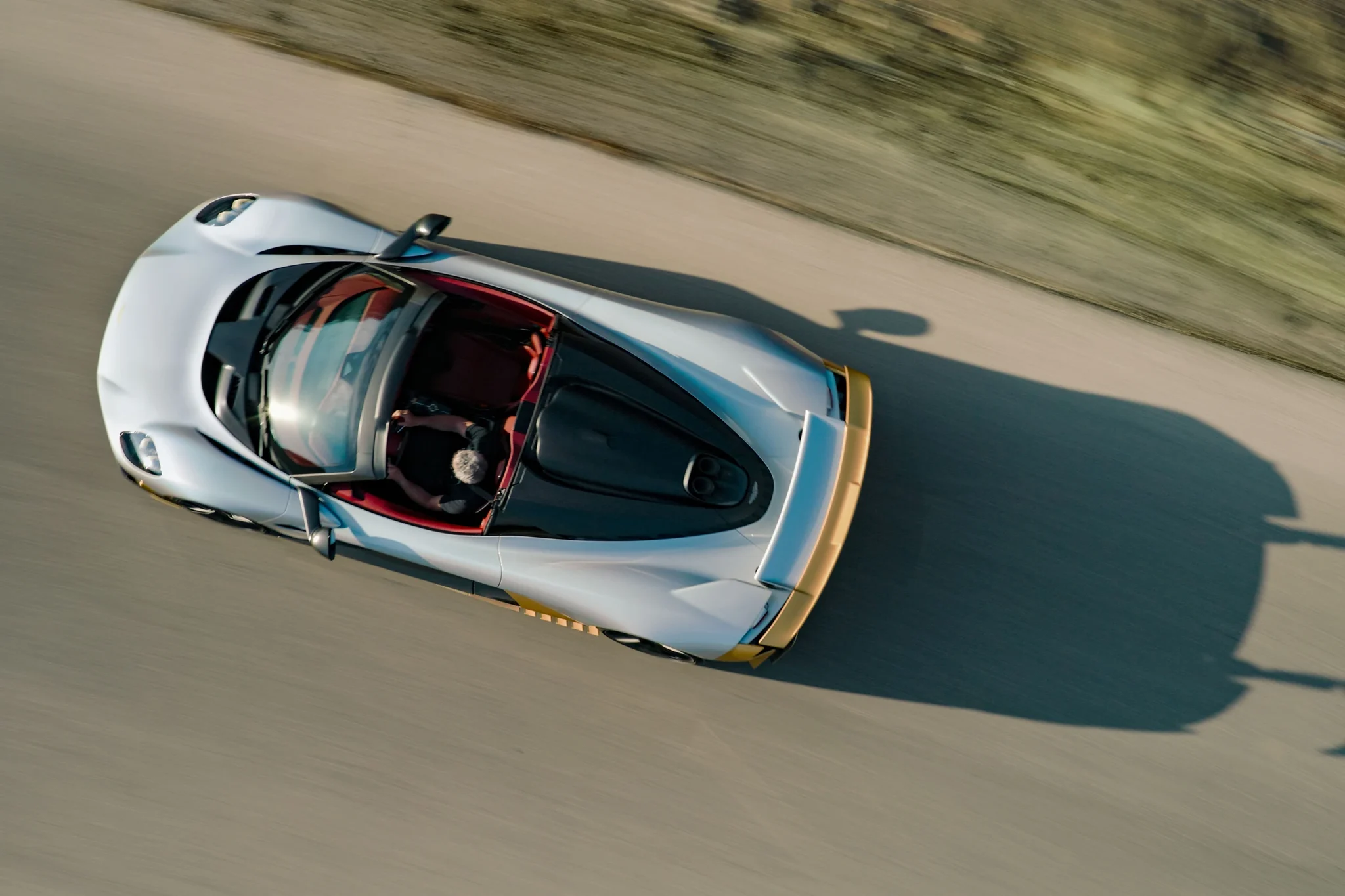 Vista cenital del Aston Martin Valhalla Spider en movimiento, con la sombra del alerón sobre el asfalto