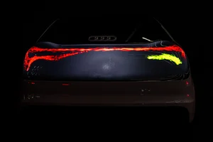 Parte trasera de un Audi con la luz digital OLED encendida en rojo y un segmento amarillo a la derecha