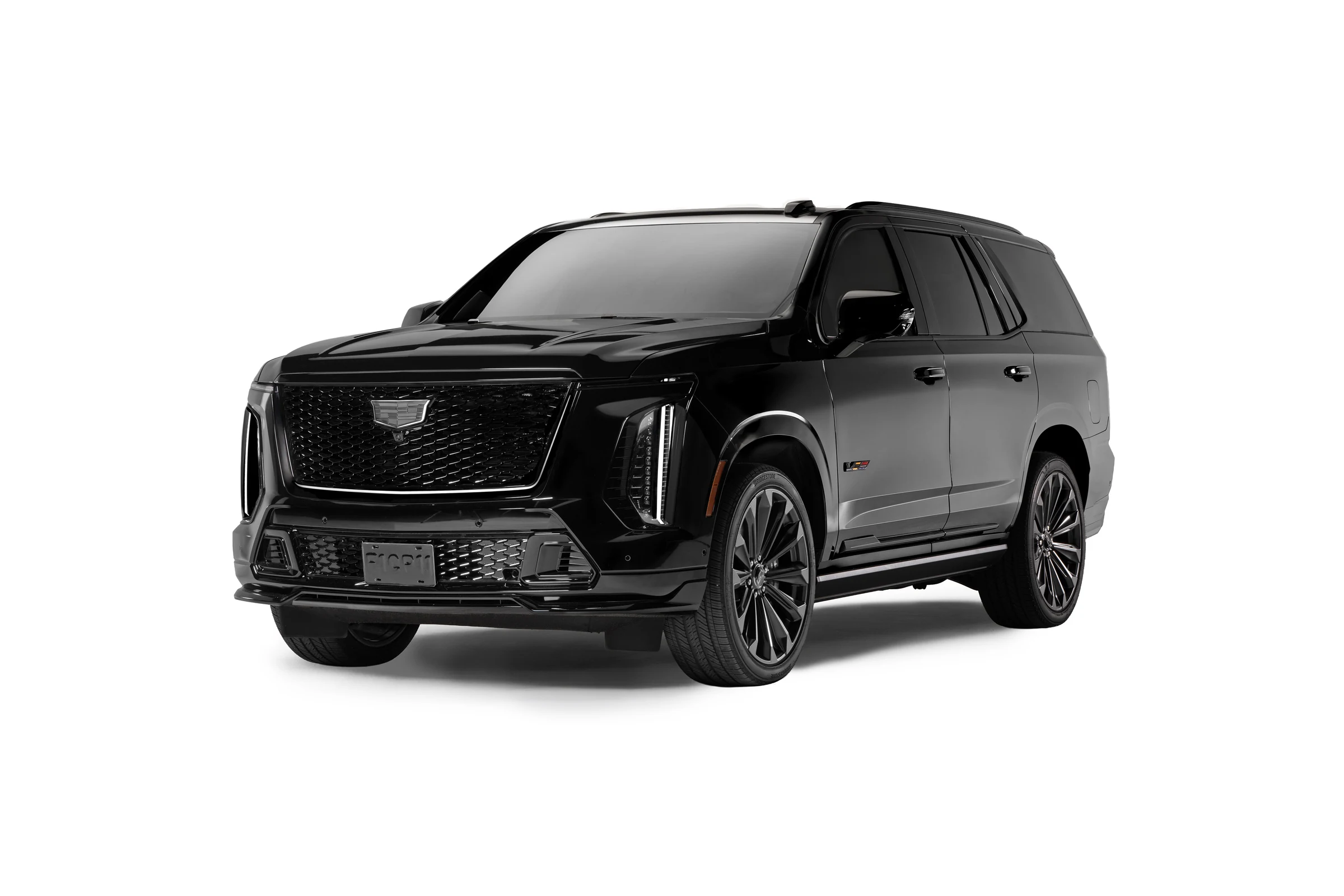 Cadillac Escalade-V Edición Checo Pérez negra vista de tres cuartos, con parrilla iluminada y emblemas en negro