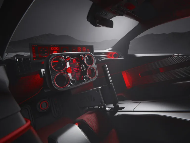 Interior del Peugeot E-T16 Concept, con asientos tipo baquet, detalles en rojo y el volante Hypersquare