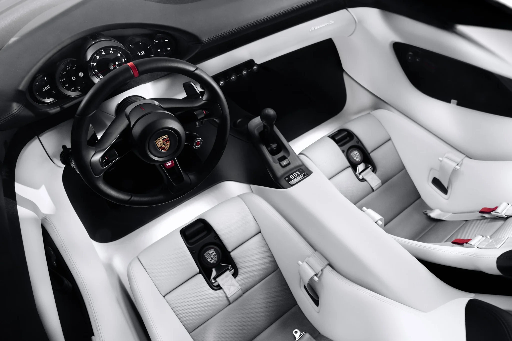 Interior del Porsche Mission S visto desde arriba, con el volante, la consola central y los asientos blancos