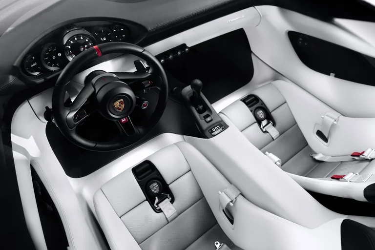 Interior del Porsche Mission S visto desde arriba, con el volante, la consola central y los asientos blancos