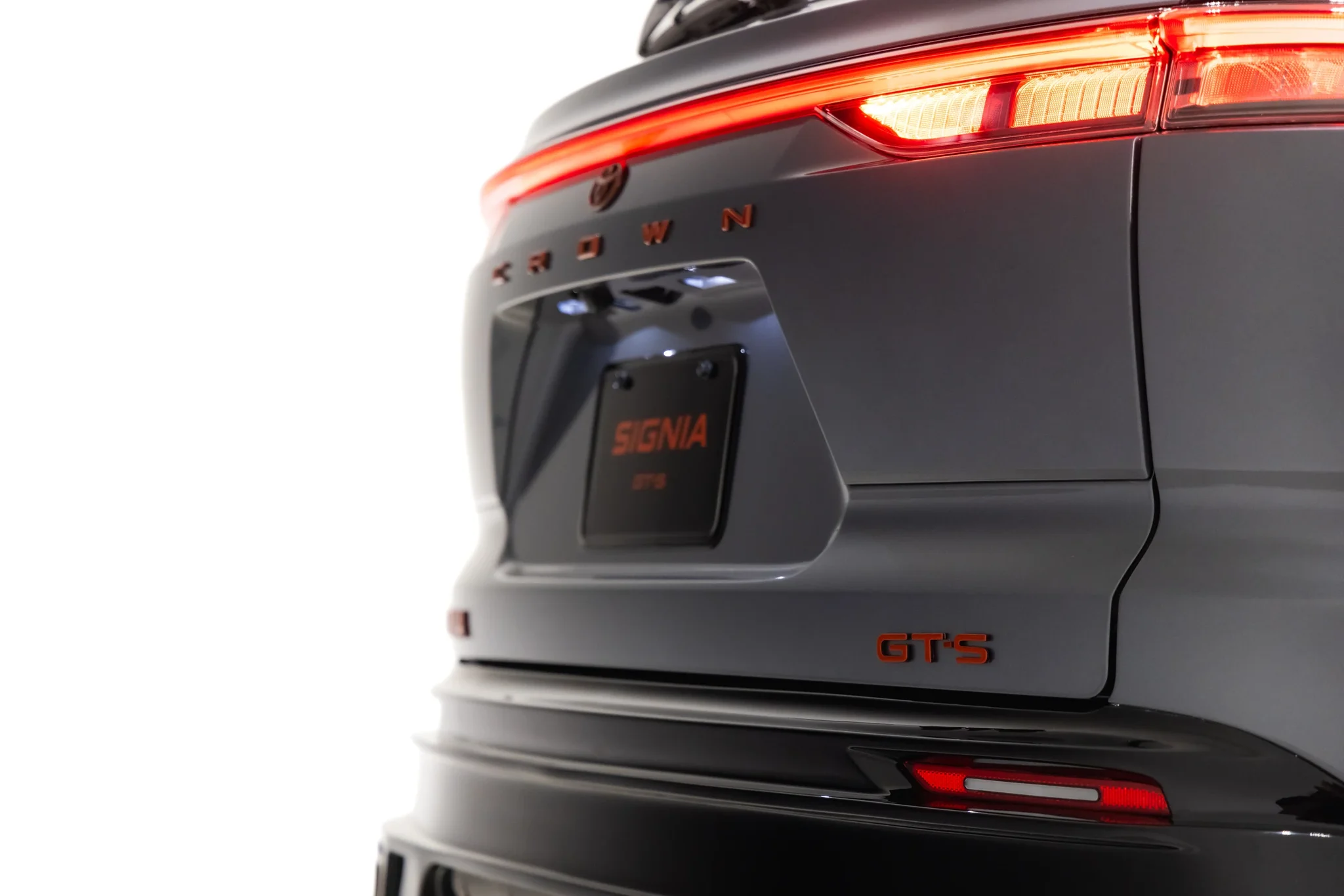 Detalle de la trasera del Toyota Crown Signia GT-S: placa con la palabra Signia, letras rojas y difusor