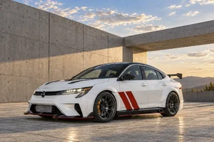 Nissan Sentra Spec-V concept blanco con franjas rojas, de tres cuartos frontales, frente a una pared de concreto