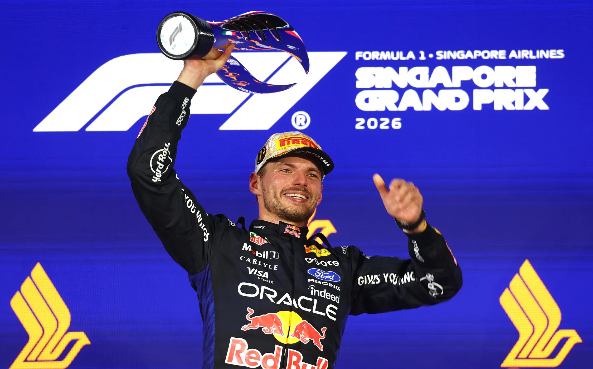 Victoria de Verstappen en Singapur: Max Verstappen sonríe y levanta el trofeo en el podio